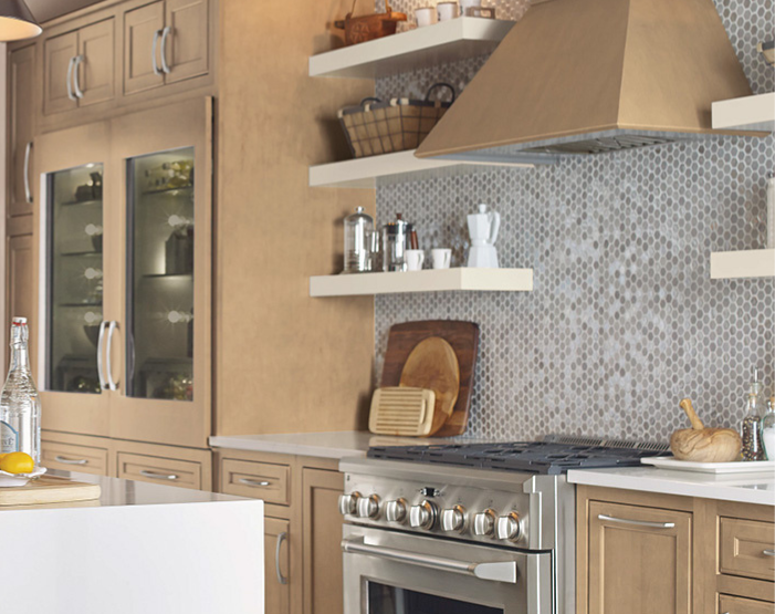 Mosaic tile backsplash in a kitchen behind a stove